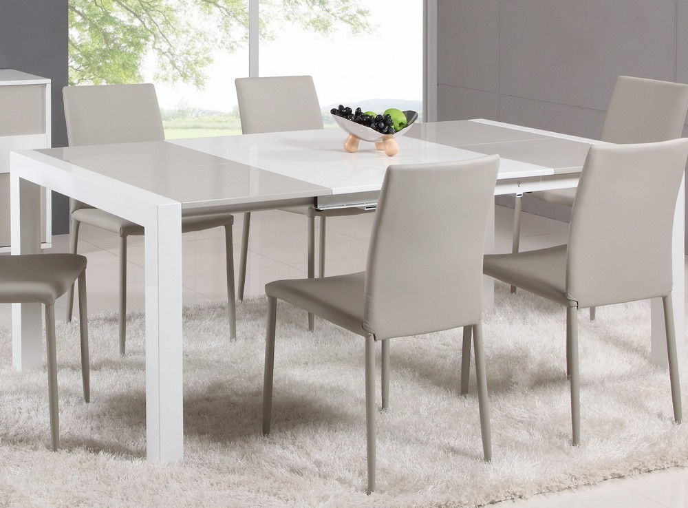 Dining area with white glossy extendable table, taupe upholstered chairs, fruit bowl centerpiece, light shag rug, window